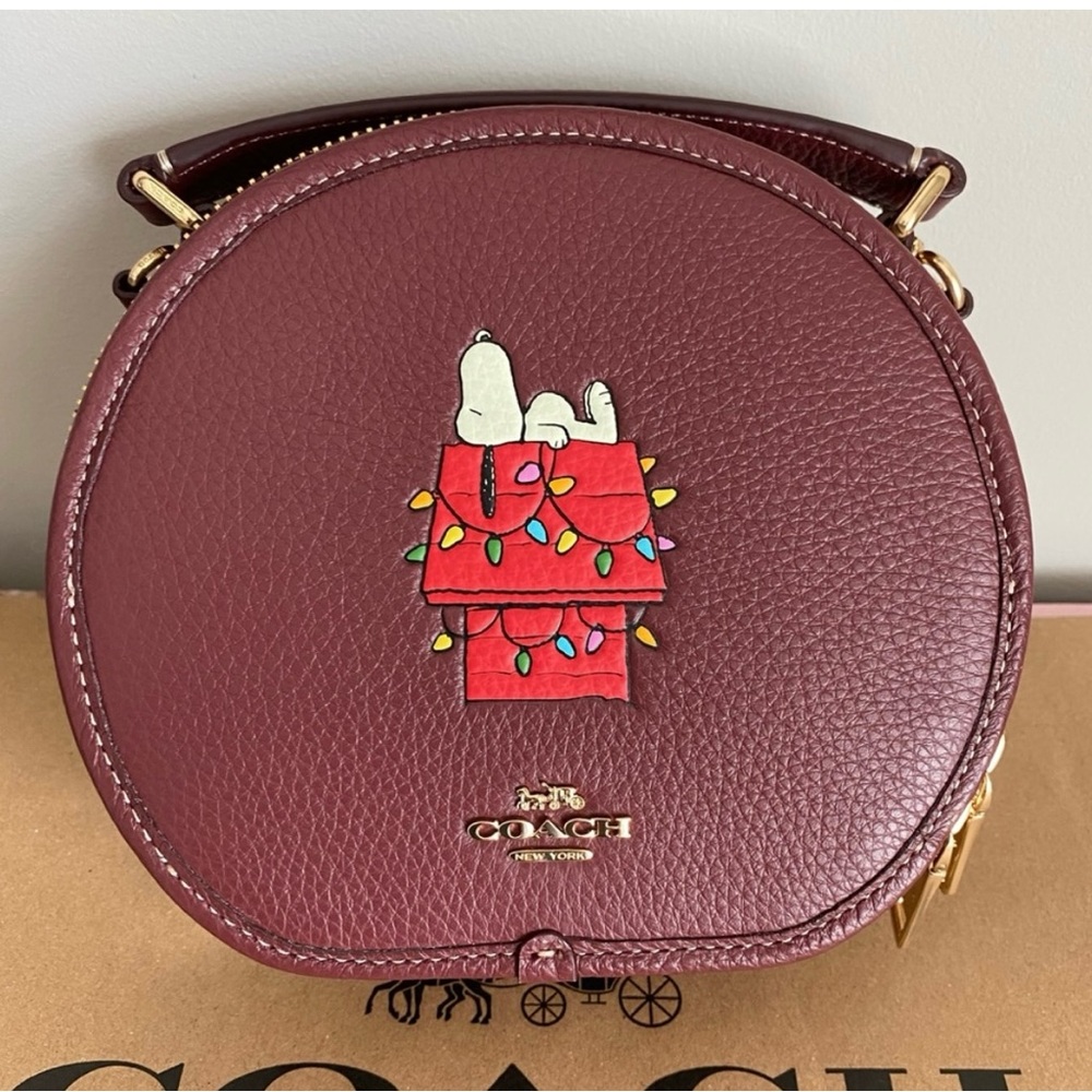 Coach Snoopy Canteen crossbody bag is more like a burgundy color.